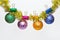 Christmas ornaments concept. Balls with glitter ornaments hang on shimmering golden tinsel. Tinsel with pinned christmas