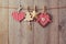 Christmas ornaments hanging on string over wooden background
