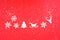 Christmas ornaments on red background. Merry Christmas word on texture of snow and snowflakes.Creative copy space for