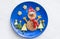 Christmas pancake shaped like snowman with fresh vegetables blue plate on wooden white table. Christmas fun food for