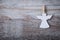 Christmas paper angel decoration over wooden background