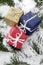 Christmas parcels on snow-covered fir branch, close up