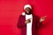Christmas, party and holidays concept. Smiling Black man with beard and santa hat, pointing fingers right at showing