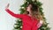 Christmas party, New Year\'s selfie girl, photographed themselves on the background of the Christmas tree, a beautiful