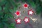 Christmas party preparation background with sewing star figures from red anf white felt, needle with thread, scissors, golden bell
