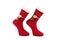 Christmas patterned  red knitted socks. Beautiful winter warm Christmas socks with a New Year`s pattern on a white background.