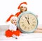 Christmas and people concept - mother with child and clock
