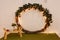 Christmas photo zone, lights, Christmas tree, huge New Year\\\'s wreath, tray with flowers, cups and candles. Green carpet, imitatio