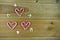 Christmas photography image with red and white stripe candy cane sweets in love heart shapes with cute iced decorations on wood