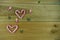 Christmas photography image with red and white stripe candy cane sweets in love heart shapes with cute iced decorations on wood