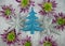 Christmas photography picture of glitter tree and star decorations with purple green flowers in snow in the background