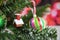 Christmas photography picture of tree branches and little red house with candy canes and red fairy lights in background