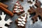 Christmas picture. Chocolate gingerbread Christmas trees and snowflakes sprinkled with flour on a dark background