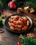 Christmas Pigs in blankets, sausages wrapped in bacon with decoration, gifts, green tree branch on wooden rustic table