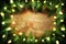 Christmas pine wreath with lights on wooden background