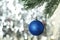 Christmas pinecone on christmas tree on lights background, close up