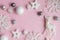 Christmas pink and white decorations on a pastel pink background with space for text. Layout of a postcar
