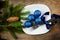 Christmas plate blue baubles pines wooden surface