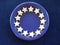 Christmas plate.  Blue ceramic plate, decorated with  home-baked cinnamon stars,  against a blu