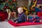 Christmas portrait of cute little newborn baby boy, dressed in christmas clothes and wearing santa hat, studio shot, winter time