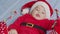 Christmas portrait of cute little newborn baby girl, wearing santa hat and dress, winter time.