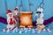 Christmas preparations of cheerful snowmen on blue festive stage