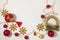 Christmas present box with red ribbon, gold decorations, balls, snowflakes and lights on a white background