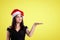 Christmas presentation of a merry girl over yellow background