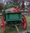 Christmas presents in antique wagon with blurred christmas tree in backround