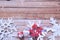 Christmas presents laid on a wooden table background with snow sparkle