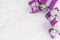 Christmas purple gifts with silver ribbon on white marble table
