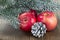 Christmas red apples, snow-covered cones