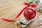 Christmas red bauble on sleigh with red ribbon bow, on wooden rustic table. Copy space