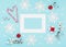 Christmas red gift, snowflakes, candy canes, empty frame on pastel blue background