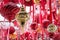 Christmas red and golden balls hanging on red ribbons in fair kiosk for workshop and sale handcrafted xmas decorations.