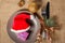 Christmas red hat and present in gift box on plate, fork and knife, cone, glittering ball and natural fir tree branch