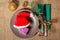 Christmas red hat and present in gift box on plate, knife and fork on green napkin, cone, glittering ball and natural fir tree br