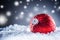 Christmas red Luxury ball in snow and abstract snowy atmosphere