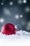 Christmas red Luxury ball in snow and abstract snowy atmosphere