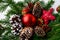 Christmas red ornaments, golden pine cones and rustic star