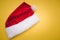 Christmas red Santa Claus hat with white pompom yellow . Decoration background