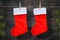 Christmas red socks on rope. Wooden background