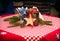 Christmas, red tablecloth with stars. wooden star, sugar, and container for candle