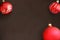 Christmas red and wavy dull balls on dark wooden table