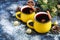 Christmas red wine mulled wine with spices and in large, yellow mugs.