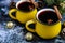 Christmas red wine mulled wine with spices and in large, yellow mugs.