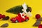 Christmas reindeer carrying large Christmas tree in toy red car