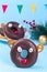 Christmas reindeer made from chocolate doughnut, pretzel cookie, marshmallow and candy, Christmas menu for kids, vertical