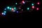 Christmas romantic decorative garland lights frame on black background with copy space