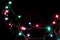 Christmas romantic decorative garland lights frame on black background with copy space